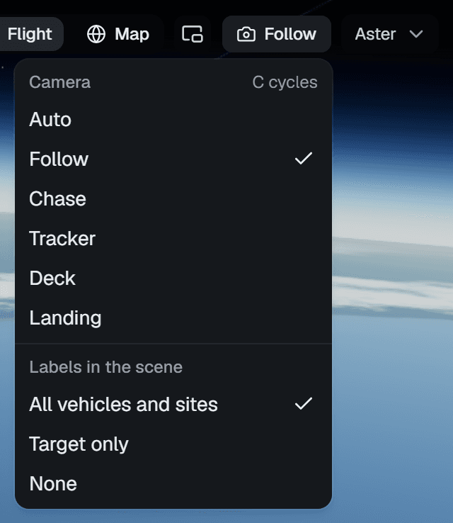 The camera menu open: Camera, C cycles; Auto, Follow (ticked), Chase, Tracker, Deck, Landing; then Labels in the scene: All vehicles and sites (ticked), Target only, None