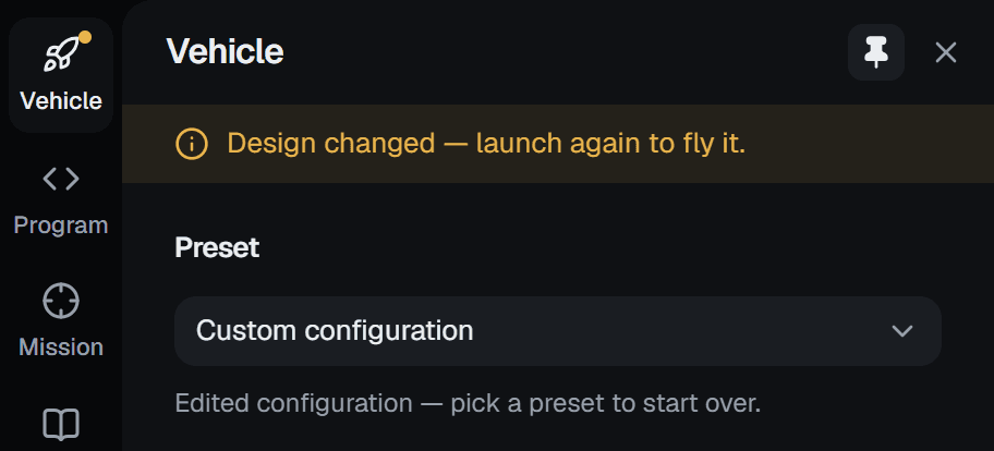 The rail and the top of the Vehicle panel during a flight: an amber dot on the Vehicle tab and a strip reading Design changed — launch again to fly it